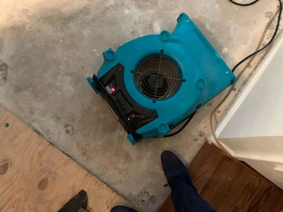 Air mover drying subfloor during Commercial Water Damage Restoration in Des Plaines